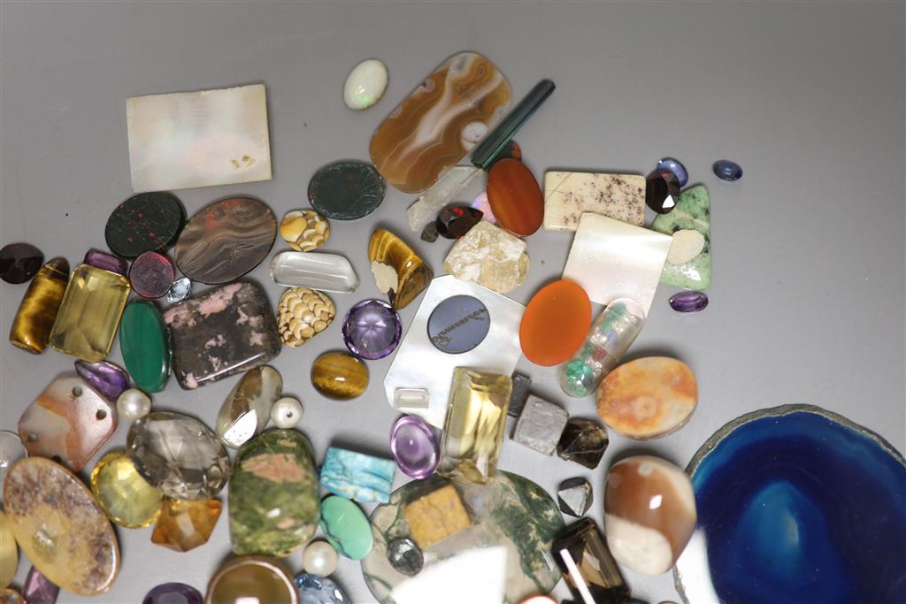 A group of loose precious and semi precious stones, including citrine, moss agate, tigers eye quartz etc.